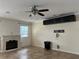 Bright living room with ceiling fan, fireplace, and tile floors at 3003 Cobham Rd, Kissimmee, FL 34758