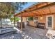 Covered back patio featuring wood ceiling, mounted television and outdoor kitchen with built-in bar at 3134 Koval Ct, Orlando, FL 32837
