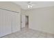 Bedroom featuring tile flooring, ceiling fan, and double door closet at 3134 Koval Ct, Orlando, FL 32837