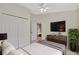 Bright bedroom featuring tile floors, a ceiling fan and a large closet at 3134 Koval Ct, Orlando, FL 32837