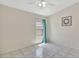Bedroom with tile flooring, ceiling fan, and a bright window view at 3134 Koval Ct, Orlando, FL 32837