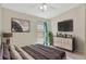 Bright bedroom featuring tile floors, a ceiling fan and a large TV at 3134 Koval Ct, Orlando, FL 32837