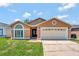Charming single-story home with a well-manicured lawn and an attached two-car garage at 3134 Koval Ct, Orlando, FL 32837