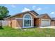 Traditional home exterior with manicured lawn and mature landscaping at 3134 Koval Ct, Orlando, FL 32837