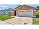 Traditional home exterior with a two-car garage and manicured lawn at 3134 Koval Ct, Orlando, FL 32837