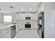 Modern kitchen featuring stainless steel appliances, white cabinetry, and quartz countertops at 3134 Koval Ct, Orlando, FL 32837