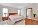 Cozy main bedroom with wood furniture, neutral bedding, and natural light creating a serene retreat at 3134 Koval Ct, Orlando, FL 32837