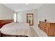 Bright bedroom with wooden furniture, large mirror, and tiled floors for a modern and airy feel at 3134 Koval Ct, Orlando, FL 32837