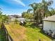 A spacious backyard with tropical landscaping featuring a shed and a boat trailer at 3211 Countryside View Dr, St Cloud, FL 34772