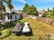 View of the grassy backyard showing two jet skis with covers sitting in the grass at 3211 Countryside View Dr, St Cloud, FL 34772