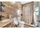 Cozy bathroom featuring tiled walls, a unique vanity, and a shower with a curtain at 3211 Countryside View Dr, St Cloud, FL 34772