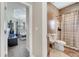 Cozy bathroom featuring tiled walls, a unique vanity, and a shower with a curtain at 3211 Countryside View Dr, St Cloud, FL 34772