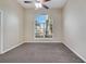 Bright bedroom with a large arched window and ceiling fan, offering natural light and comfort at 3211 Countryside View Dr, St Cloud, FL 34772