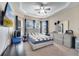 Bright bedroom with tray ceiling, neutral carpet, large windows, and stylish furniture at 3211 Countryside View Dr, St Cloud, FL 34772