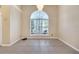 Bright dining room features a large arched window, neutral paint, and tiled floors at 3211 Countryside View Dr, St Cloud, FL 34772