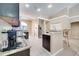 Well-lit kitchen with stainless steel appliances, granite countertops, and an adjacent breakfast bar at 3211 Countryside View Dr, St Cloud, FL 34772