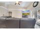 Living room featuring a leather sectional, ceiling fan, and entertainment center with fireplace at 3211 Countryside View Dr, St Cloud, FL 34772