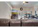 Spacious living room featuring a leather sectional, entertainment center with TV, and sliding doors to patio at 3211 Countryside View Dr, St Cloud, FL 34772