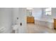 Well-lit main bathroom with tub, tile floors, double vanity and separate toilet space at 3211 Countryside View Dr, St Cloud, FL 34772