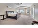 Spacious main bedroom with carpet, ceiling fan, multiple windows, and outdoor access at 3211 Countryside View Dr, St Cloud, FL 34772