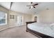 Bright main bedroom featuring carpet, vaulted ceiling, ceiling fan, and a sliding glass door at 3211 Countryside View Dr, St Cloud, FL 34772
