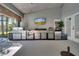 An outdoor kitchen featuring stainless steel appliances, a grill, and a television for entertainment at 3211 Countryside View Dr, St Cloud, FL 34772