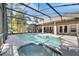 Beautiful pool and spa area surrounded by a screen enclosure with an outdoor kitchen and patio at 3211 Countryside View Dr, St Cloud, FL 34772