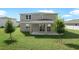 A spacious backyard featuring a covered patio and lush green lawn, perfect for outdoor entertaining at 3629 Sublett Loop, Tavares, FL 32778