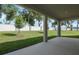 Spacious backyard featuring a covered patio, with lush green lawn and privacy fence at 3629 Sublett Loop, Tavares, FL 32778