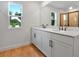 Bright bathroom with double sinks, quartz countertops, modern fixtures, and a walk-in glass shower at 3629 Sublett Loop, Tavares, FL 32778