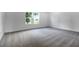 Spacious bedroom showcasing plush carpeting and a window view, perfect for relaxation and comfort at 3629 Sublett Loop, Tavares, FL 32778