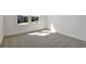 Bright empty bedroom with carpeted floor and two windows at 3629 Sublett Loop, Tavares, FL 32778