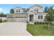 Inviting two-story home with a three-car garage, stone accents, and a well-manicured lawn at 3629 Sublett Loop, Tavares, FL 32778