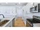 A bright modern kitchen featuring stainless steel appliances, and bright white cabinetry at 3629 Sublett Loop, Tavares, FL 32778