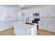 Bright kitchen featuring white cabinetry, stainless steel appliances, and a stylish island with seating at 3629 Sublett Loop, Tavares, FL 32778