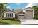 Charming single-Gathering home featuring stone accents and a two-car garage at 3723 Malad Way, Tavares, FL 32778