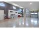 Spacious garage featuring epoxy floor, mural on the wall, multiple bays and lots of storage space at 3723 Malad Way, Tavares, FL 32778