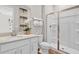 Well-lit bathroom with a white vanity, a glass-enclosed shower, and modern fixtures for a clean and functional space at 4071 Bannock Ave, Tavares, FL 32778
