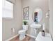 Small, modern bathroom features clean lines, an oval mirror, and contemporary fixtures at 4071 Bannock Ave, Tavares, FL 32778