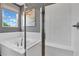 Bright bathroom showcasing a soaking tub with subway tile surround and a frameless glass shower enclosure at 4071 Bannock Ave, Tavares, FL 32778