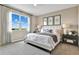 Bright bedroom with plush carpet, large window, and neutral color scheme, creating a serene and inviting space at 4071 Bannock Ave, Tavares, FL 32778