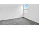 Neutral bedroom featuring gray carpet flooring and a window allowing ample natural light at 4071 Bannock Ave, Tavares, FL 32778