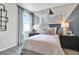 Stylish bedroom featuring a geometric accent wall, modern artwork, and comfortable bedding for a contemporary retreat at 4071 Bannock Ave, Tavares, FL 32778