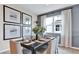Elegant dining room with modern art, a dark wood table set for six, and bright natural light at 4071 Bannock Ave, Tavares, FL 32778