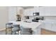 Stylish kitchen with a large island, stainless steel appliances, and modern white cabinets at 4071 Bannock Ave, Tavares, FL 32778