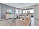 Bright living room with neutral decor, comfortable seating, and scenic views through large sliding doors at 4071 Bannock Ave, Tavares, FL 32778