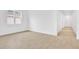 Bright, airy living room featuring wood-look tile flooring and large windows with view to backyard at 4071 Bannock Ave, Tavares, FL 32778
