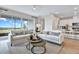 Comfortable living room with neutral tones, plush sofas, and access to outdoor views through sliding glass doors at 4071 Bannock Ave, Tavares, FL 32778