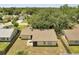 Aerial shot of home with fenced in backyard and mature shade trees on the property at 42 Chip Ct, Kissimmee, FL 34759