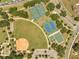 Overhead shot showcases basketball and tennis courts, a baseball field, and walking paths at 42 Chip Ct, Kissimmee, FL 34759